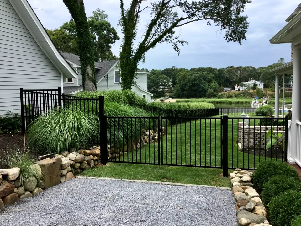 Four-foot black aluminum backyard fence and gate in Mattituck, New York.