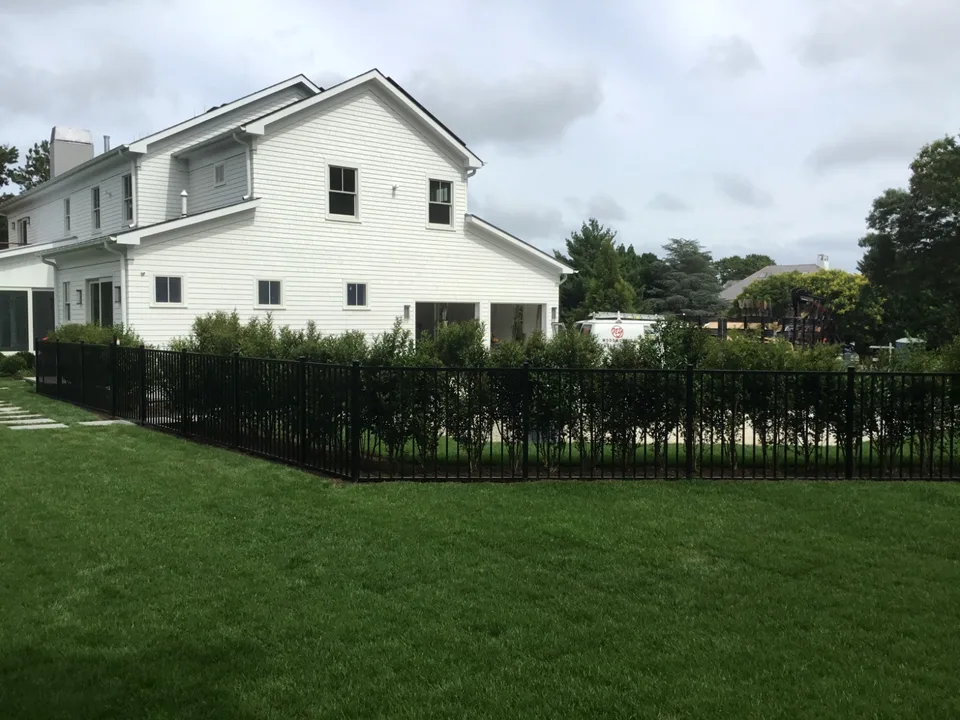 Four-foot black aluminum perimeter fence at a landscaped Southampton, New York residence.