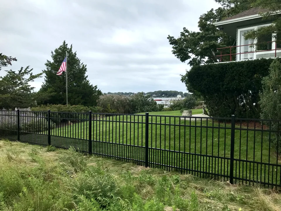 Long run of four-foot black aluminum fence with puppy pickets in Sag Harbor, New York.