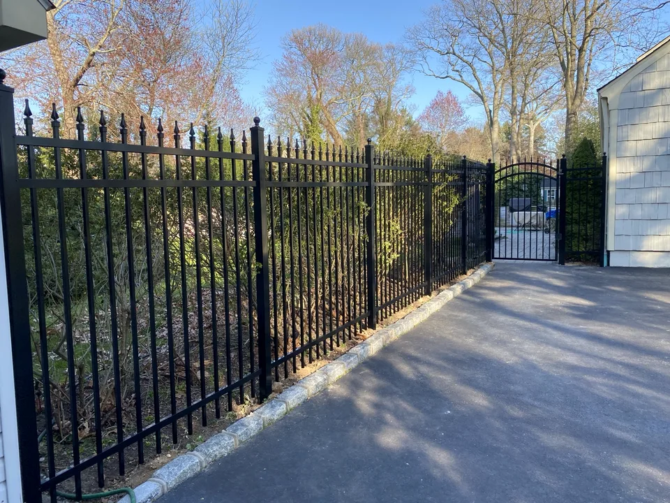 Six-foot black Jerith aluminum Estate fence extending along a residential driveway in Mount Sinai, New York.