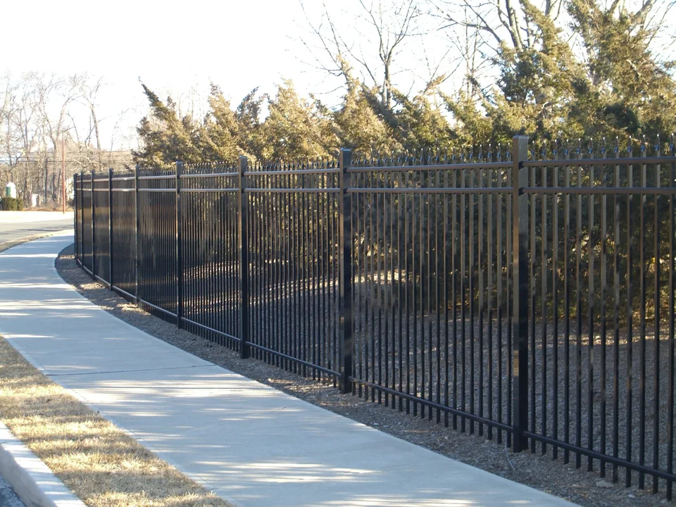 Six-foot black Ultra Aluminum UAS 100 commercial fence following a sidewalk at a 55-and-older residential community in Stony Brook, New York.