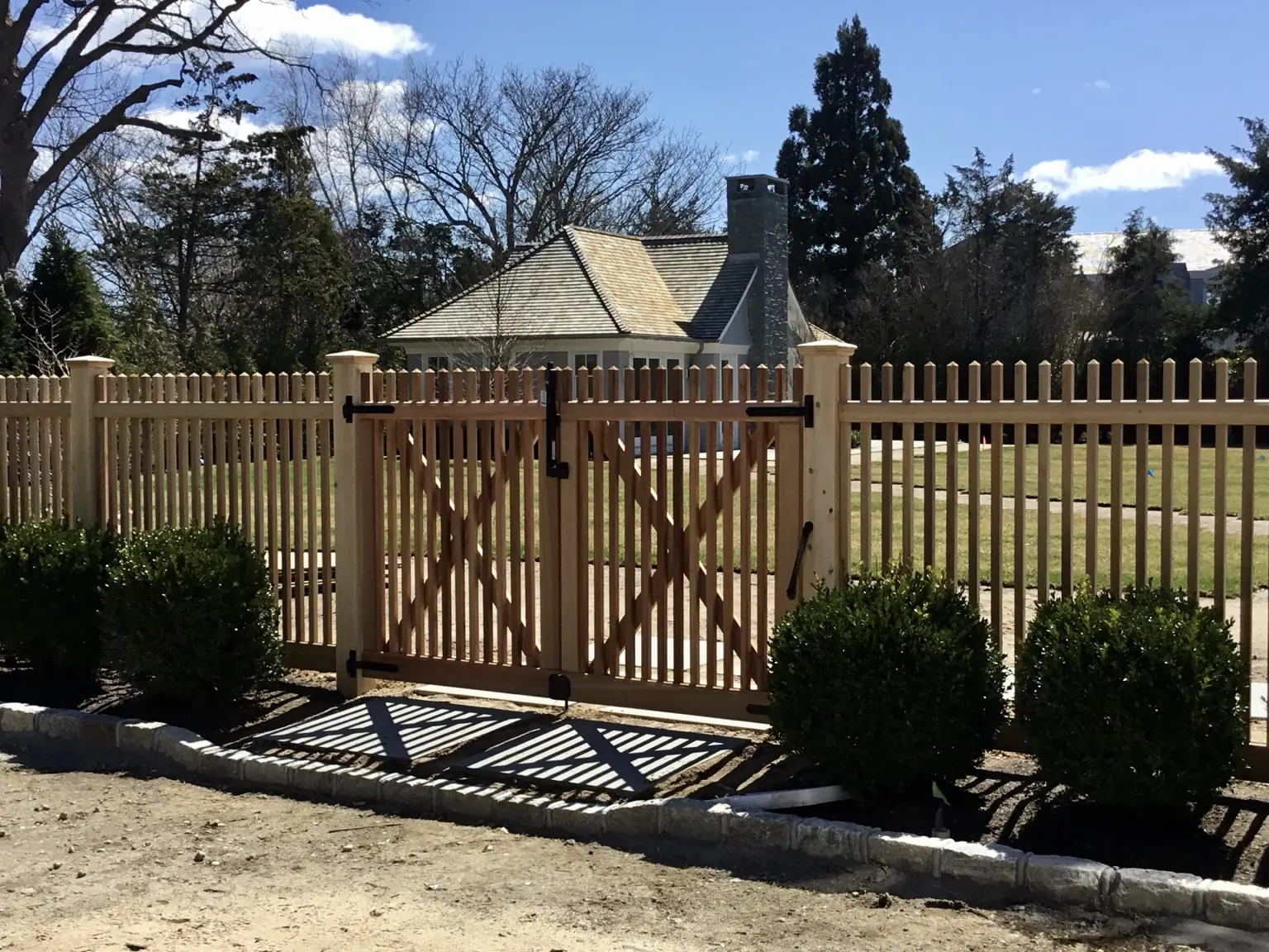 Custom cedar fence and double gate at a Southampton residence