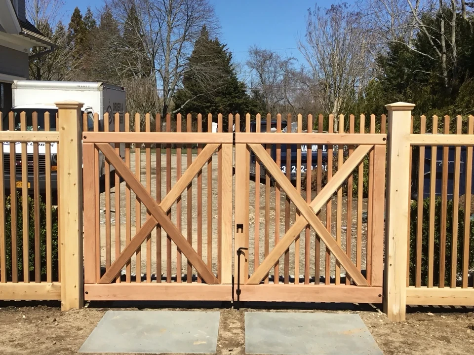 Straight-on view of custom X-braced cedar double gate in Southampton, NY