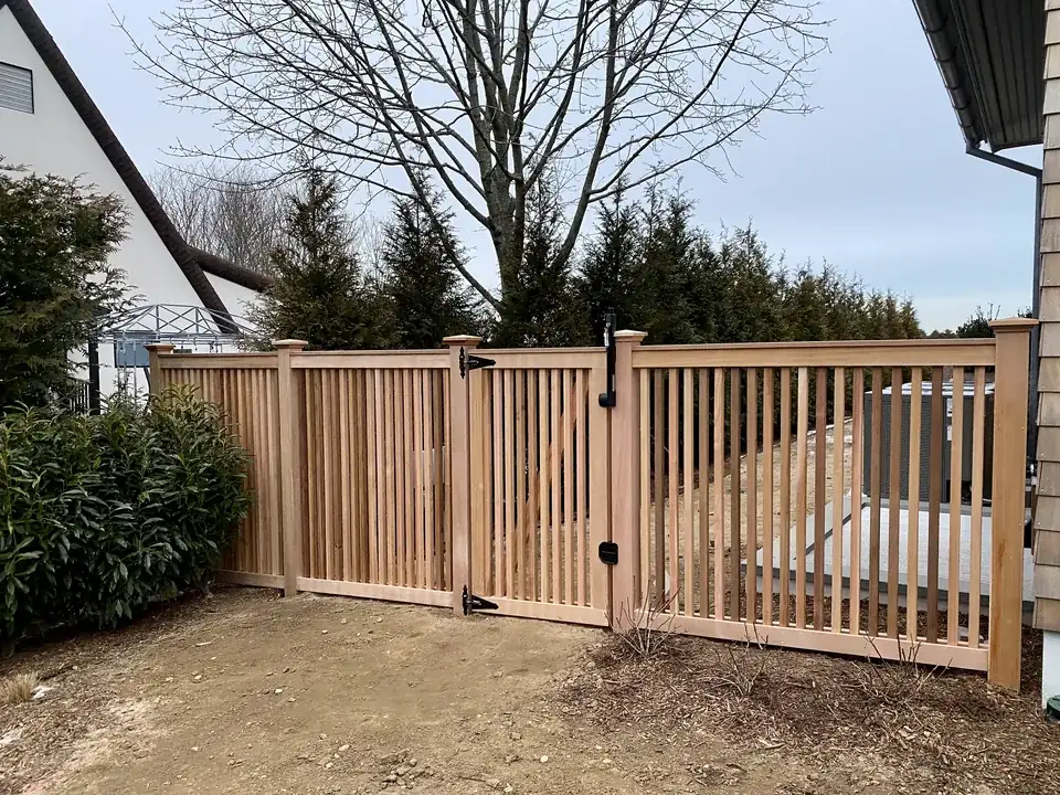 Clear cedar fence held level as the ground elevation changes in Southampton