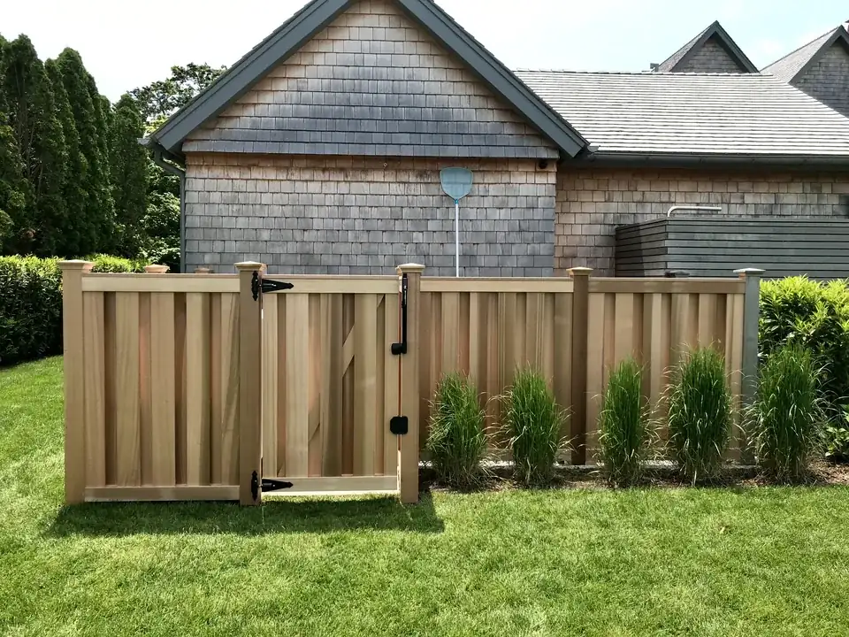 Clear cedar shadowbox screening around pool and air-conditioning equipment