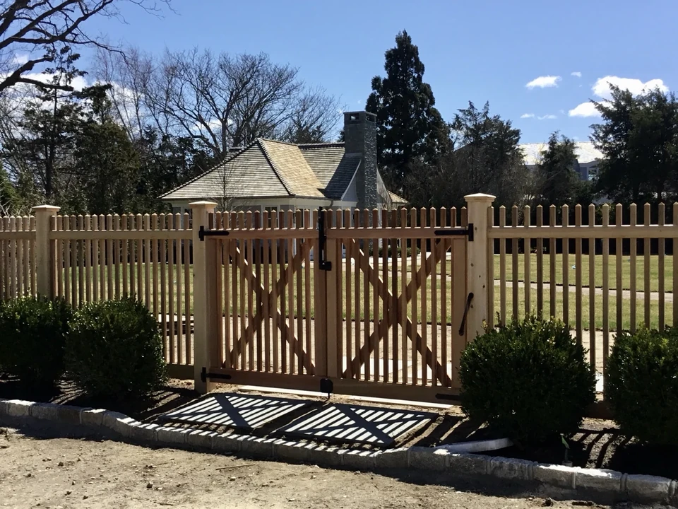 Angled view of cedar gate, capped posts and black hardware in Southampton, NY