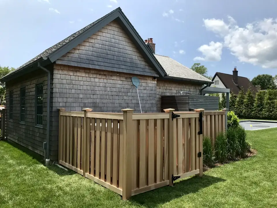 Finished clear cedar board-on-board equipment screening at a Southampton home