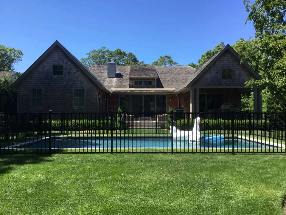 Four-foot black aluminum pool fence integrated with landscaping in The Springs, East Hampton, New York.
