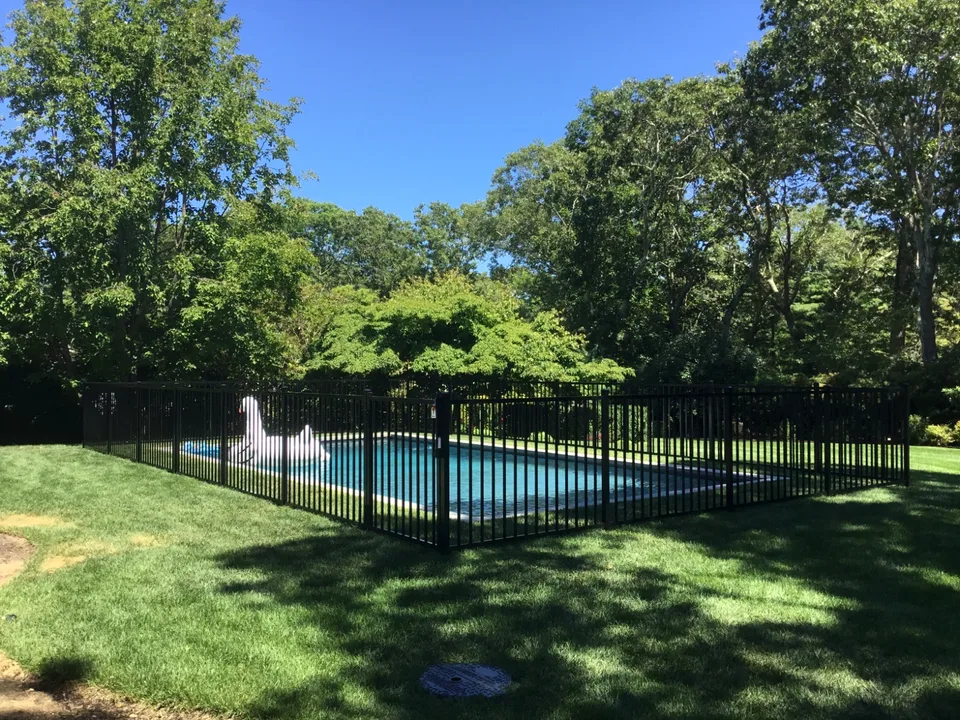 Wide view of a four-foot black aluminum pool fence in The Springs, East Hampton, New York.