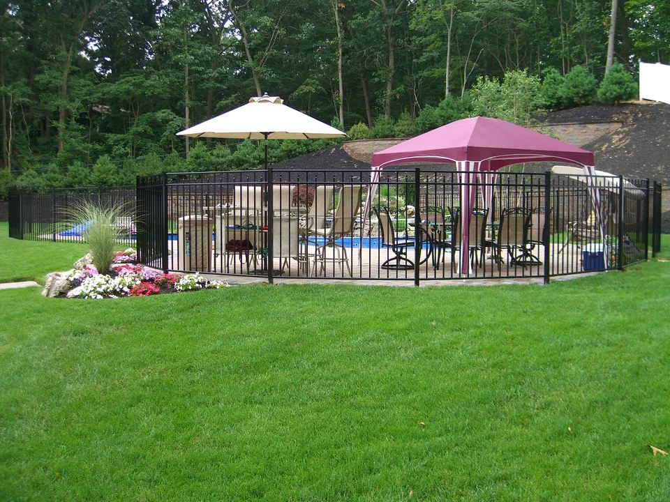 Wide view of a 54-inch black aluminum pool fence surrounding a residential pool in Dix Hills, New York.