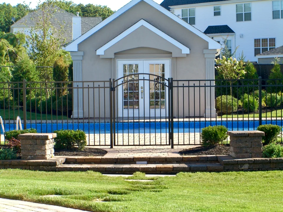 54-inch black aluminum pool fence and gate enclosing an inground pool in Miller Place, New York.