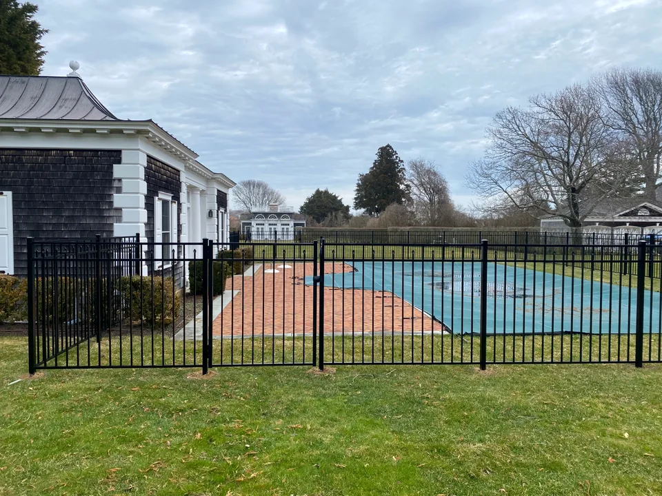54-inch Style 200 black aluminum fence beside a residential pool in Southampton, New York.
