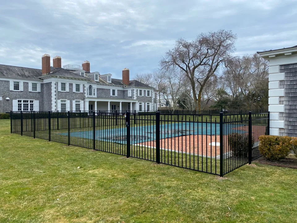 54-inch black aluminum pool fence shown across a Southampton residential property.