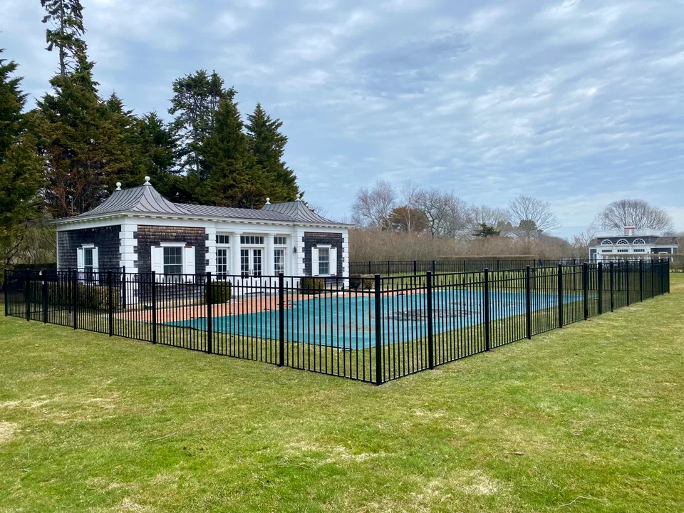 Wide view of a 54-inch Style 200 black aluminum pool fence in Southampton, New York.