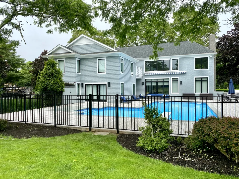 Fifty-four-inch black Style 202 aluminum fence enclosing a landscaped residential pool in Remsenburg, New York.