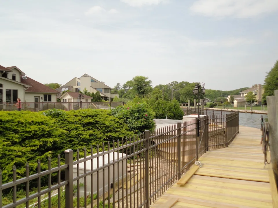 Aluminum perimeter fence along a residential canal property in East Islip, New York