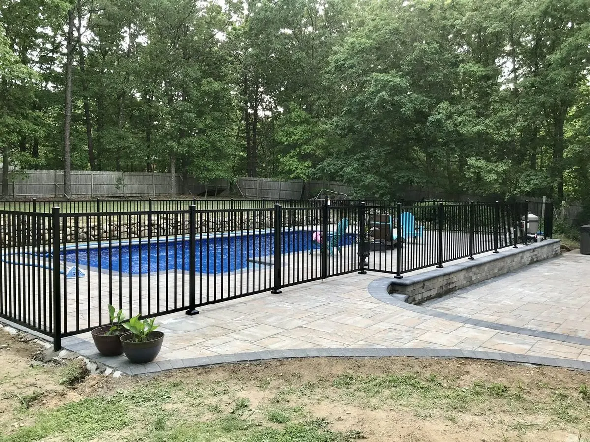 Black aluminum pool fence installation in Westhampton, New York