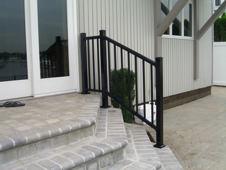 Black aluminum railing at exterior waterfront steps in Seaford, New York