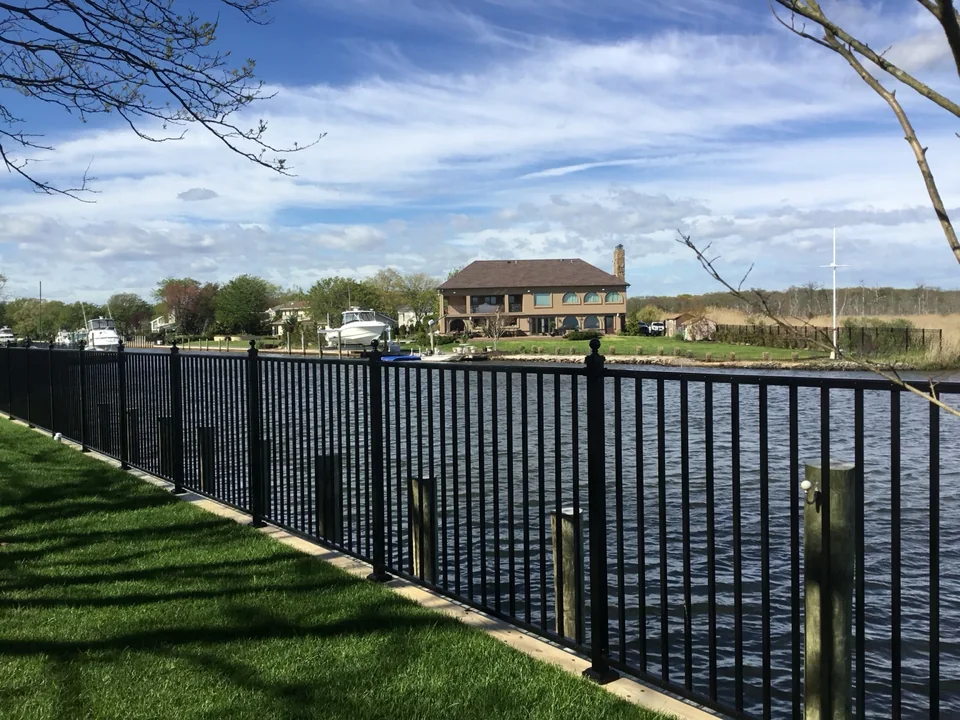 Black aluminum waterfront fence along the canal in The Moorings, East Islip
