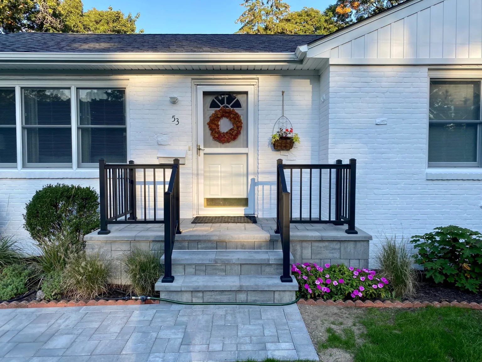 Black aluminum railing at the front stoop or backyard patio of a Bellport home