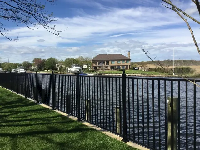 Black aluminum waterfront fence installation in Islip, New York