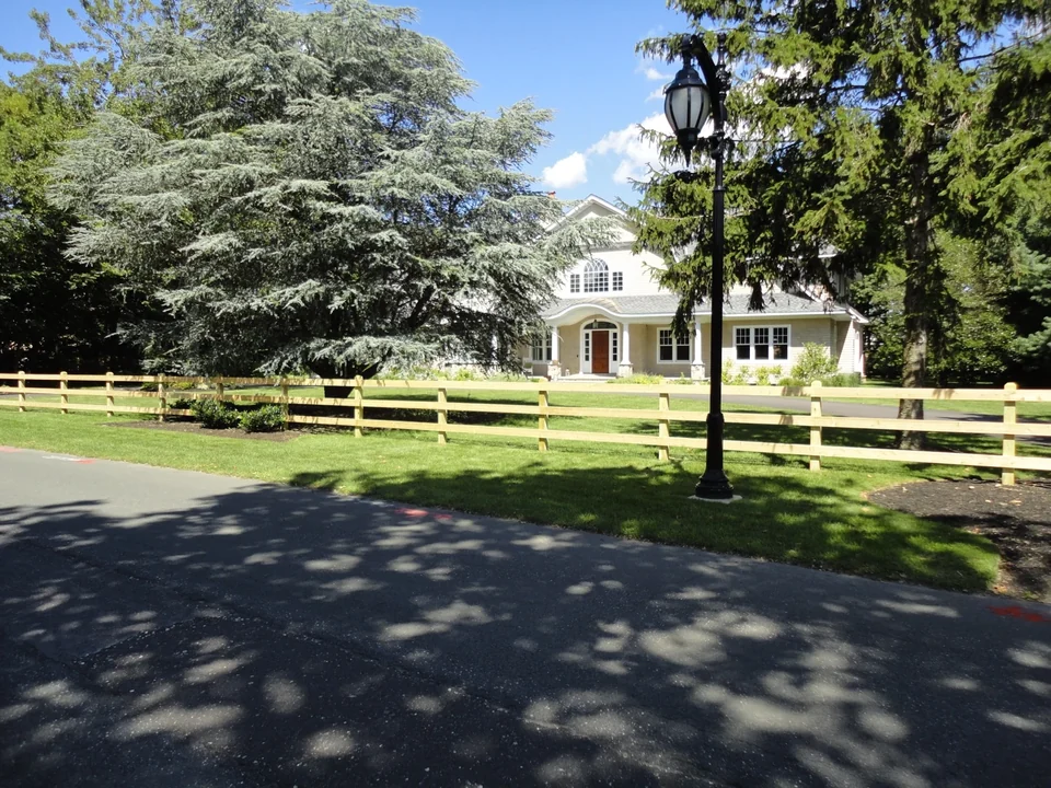 Cedar board fence and matching double driveway gate at a Bay Shore home