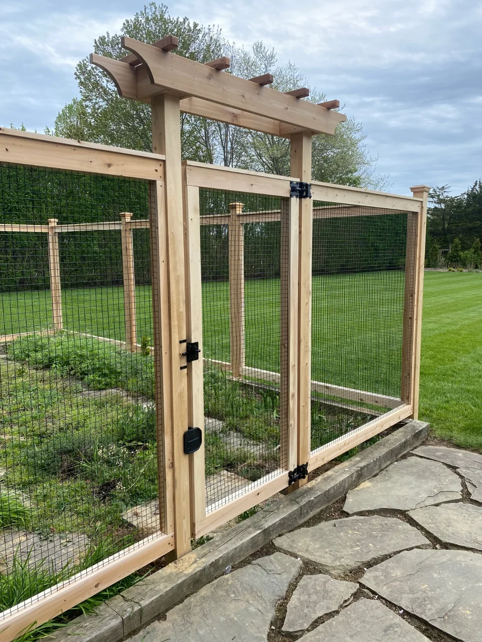 Close view of cedar arbor gate construction on a Sagaponack garden enclosure
