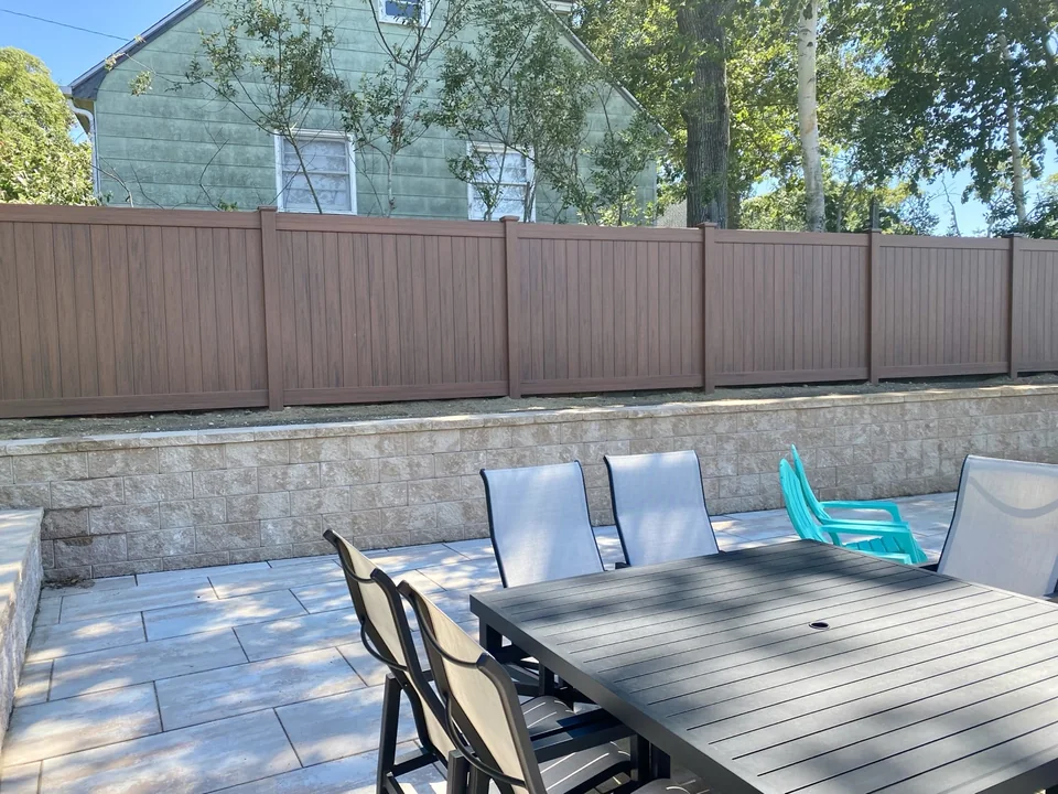 Genuine dining-terrace view of the completed cedargrain PVC privacy fence in Sag Harbor