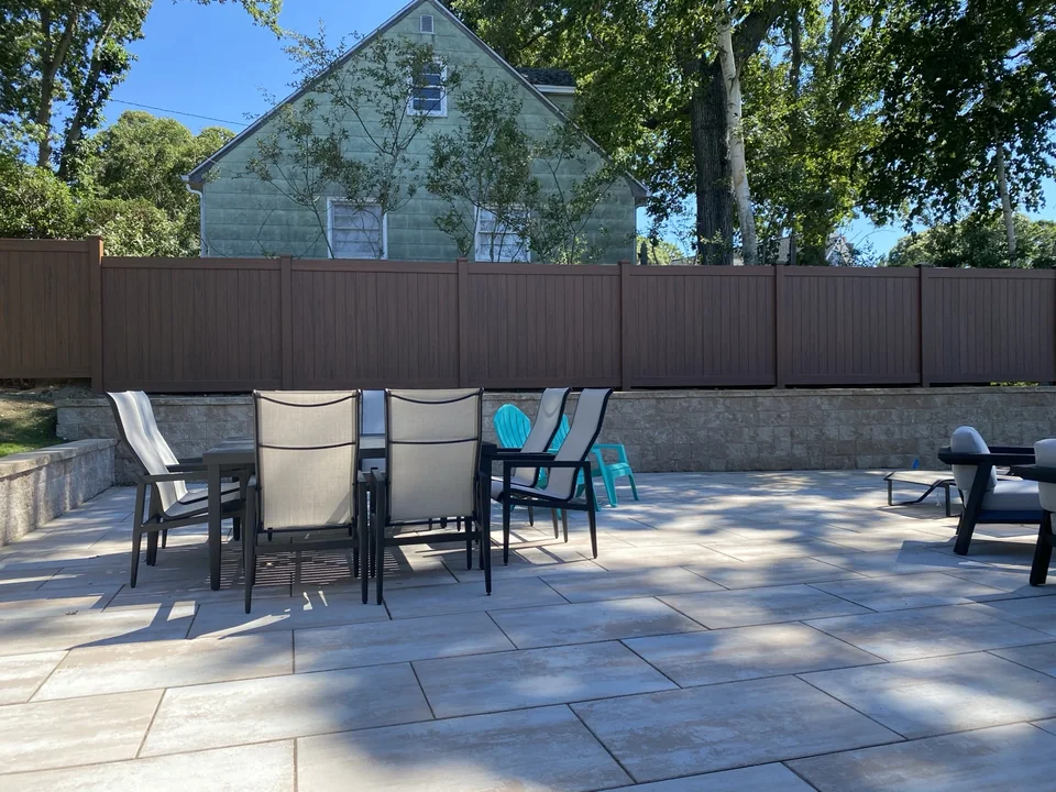 Wide genuine finished view of the cedargrain PVC privacy fence enclosing the Sag Harbor terrace