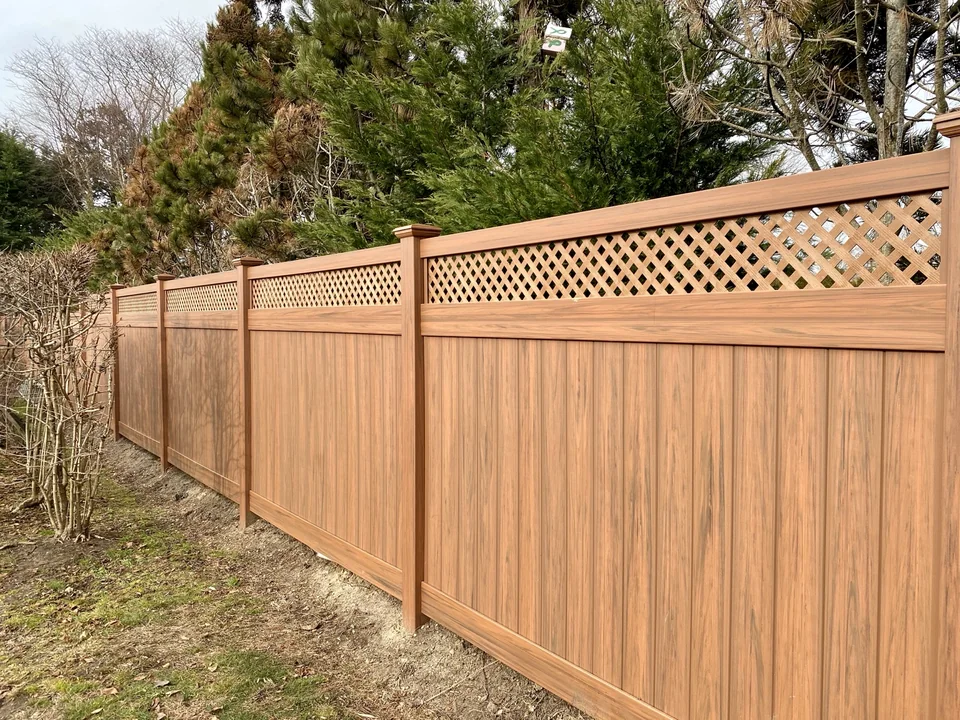 Long Cedargrain vinyl privacy fence with lattice top in West Islip, New York