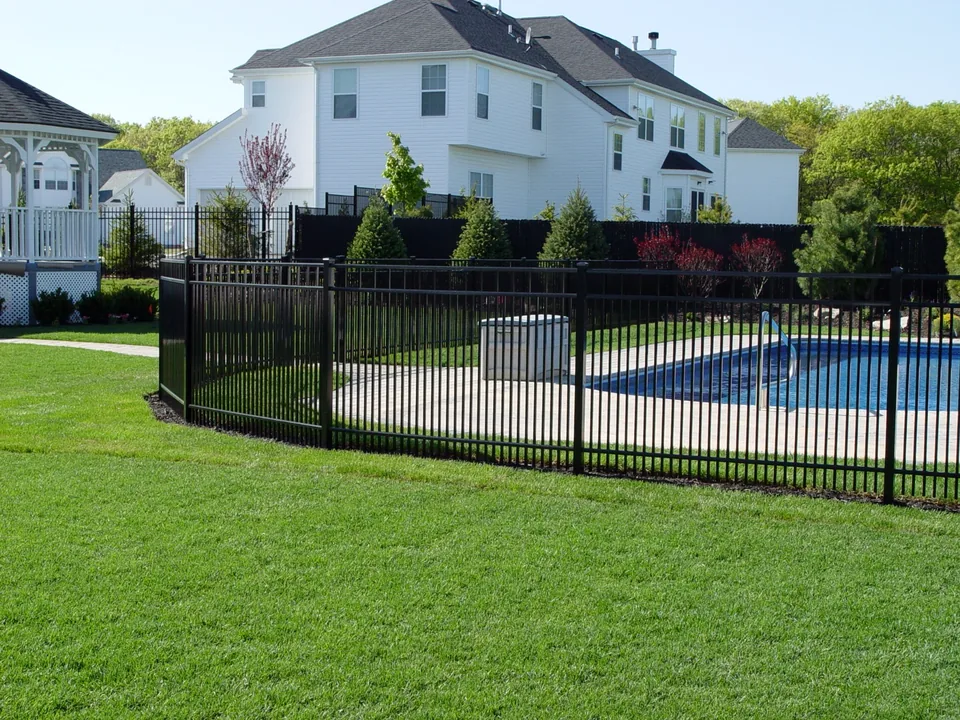 Close-spaced black aluminum fence enclosing the pool area in Miller Place, New York