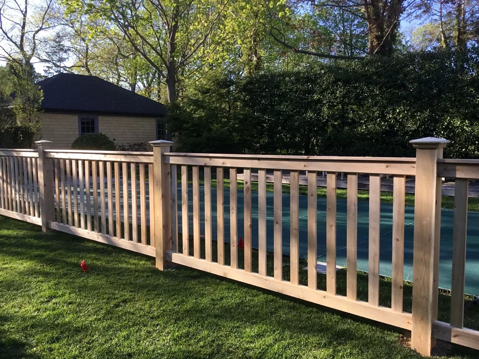 White cedar fence rails, pickets and capped posts at a Bellport Village residence