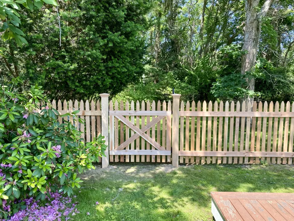 Crossbuck cedar gate detail, framed by the surrounding planting