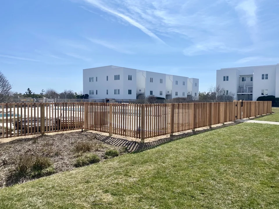 Long straight run of cedar swimming pool fence in Montauk