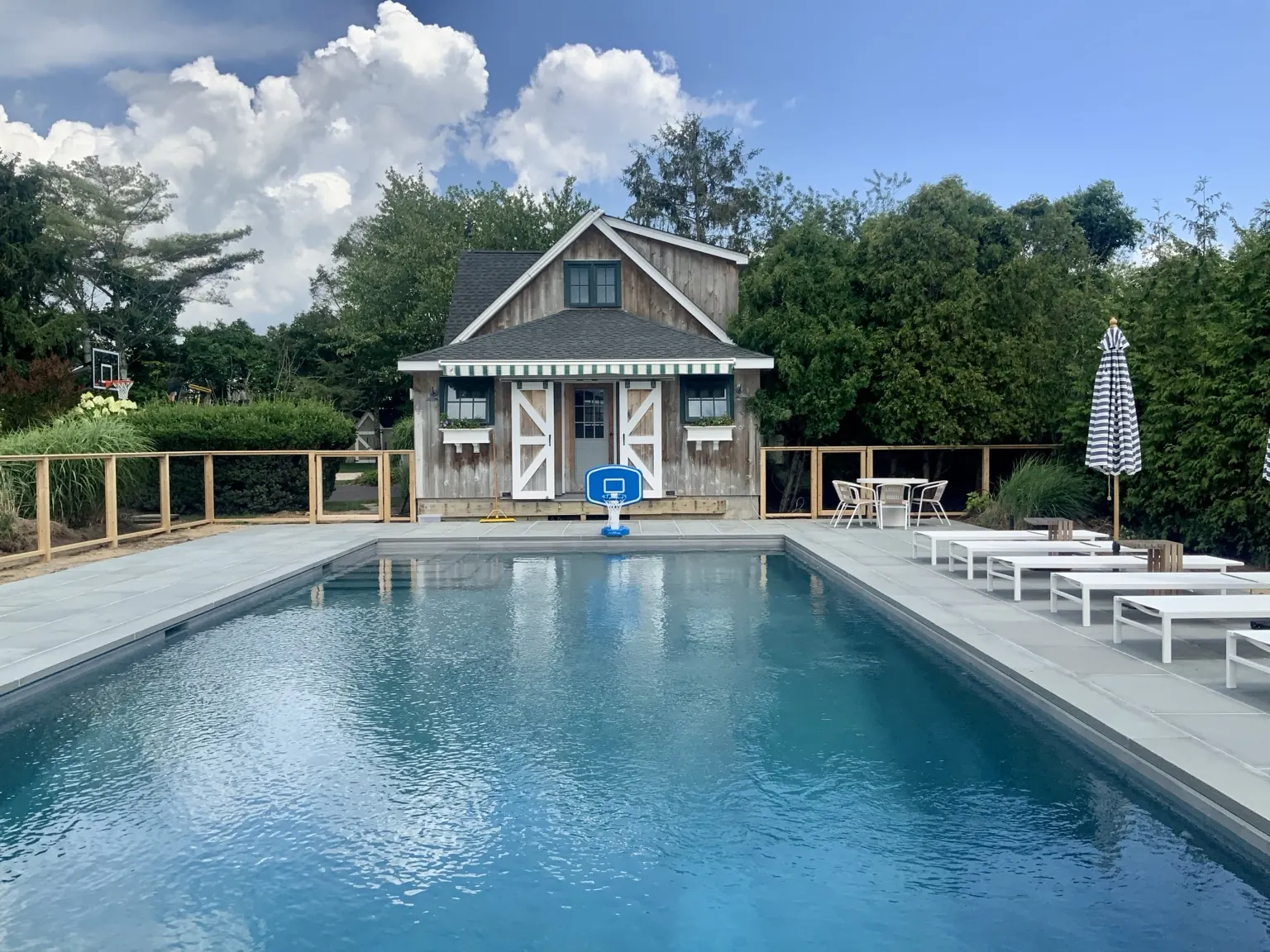 Custom cedar framed wire pool fence surrounding a pool in Westhampton, New York