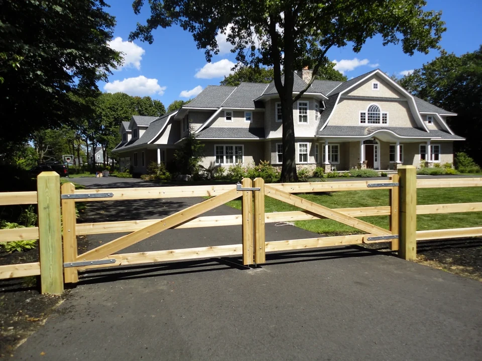 Custom double driveway gate with 8x8 pressure-treated posts and agricultural-style hardware