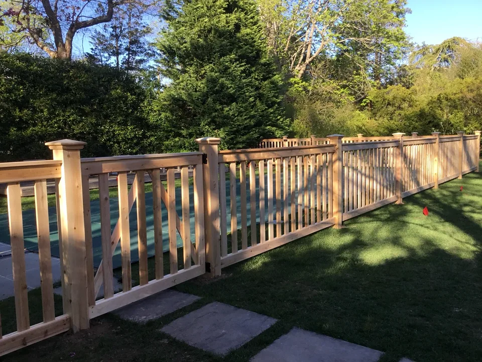 Custom white cedar gate with diagonal bracing and black hardware in Bellport Village