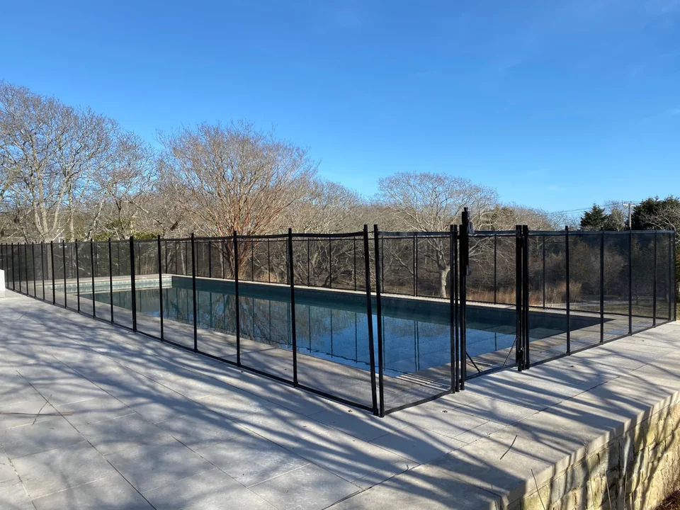 Long straight run of 4-foot Guardian Premier black pool fence in Montauk