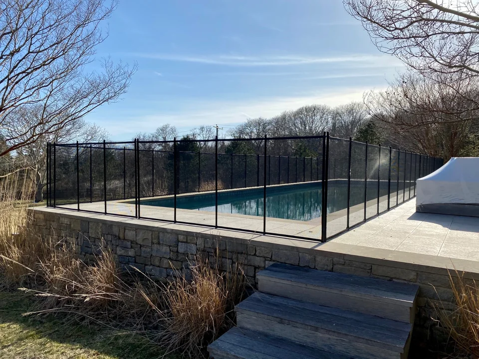 Guardian Premier black pool fence surrounding an elevated stone pool terrace in Montauk