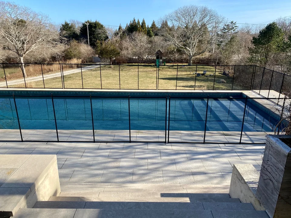 Guardian Premier removable pool fence with expansive Montauk landscape beyond the pool