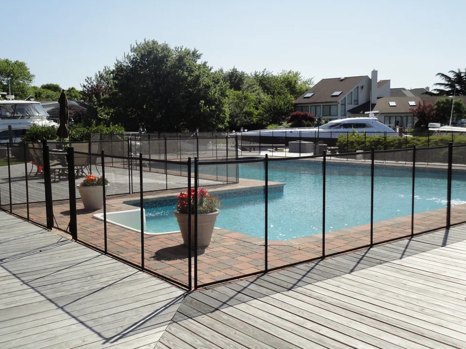 Removable mesh pool fence overlooking a canal in The Moorings, East Islip, New York