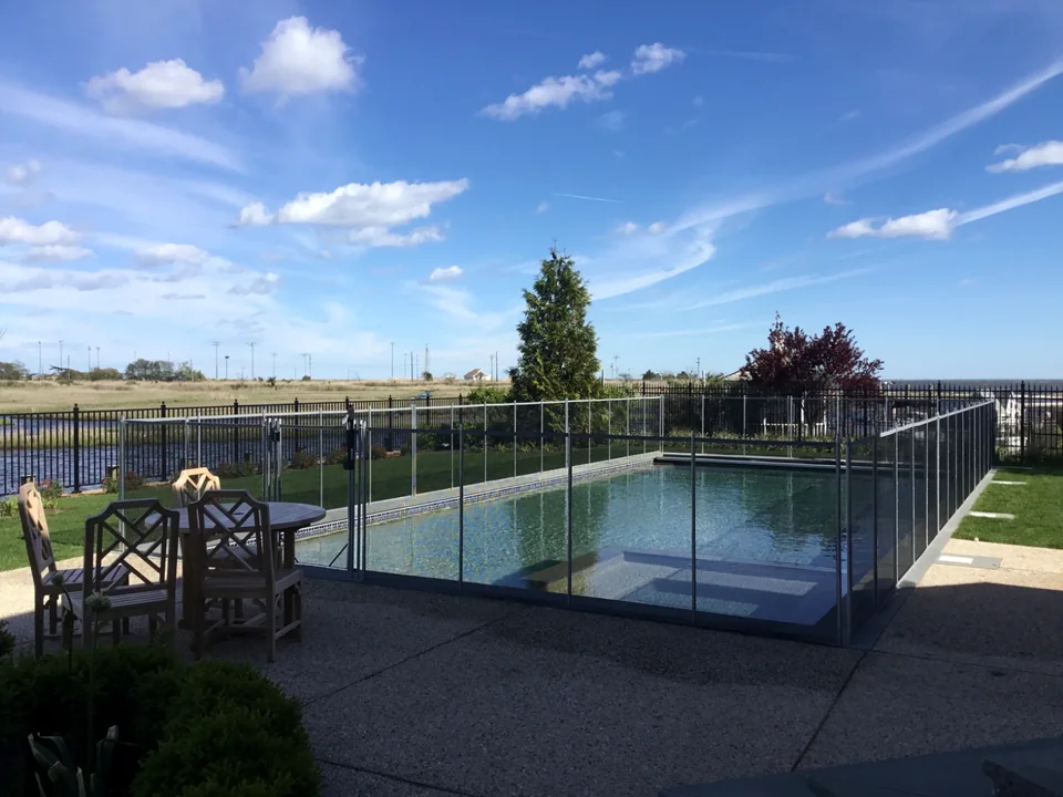 Guardian Vanishing pool fence around a waterfront pool in The Moorings, East Islip