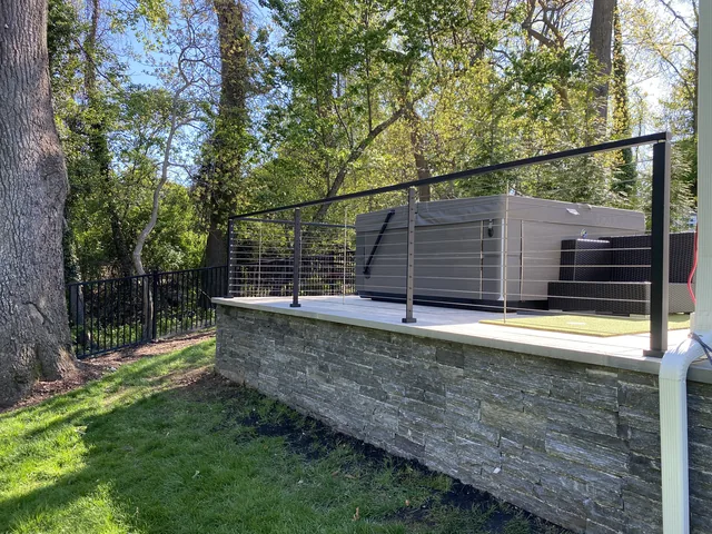 Modern aluminum cable railing at a raised stone terrace in St. James, New York