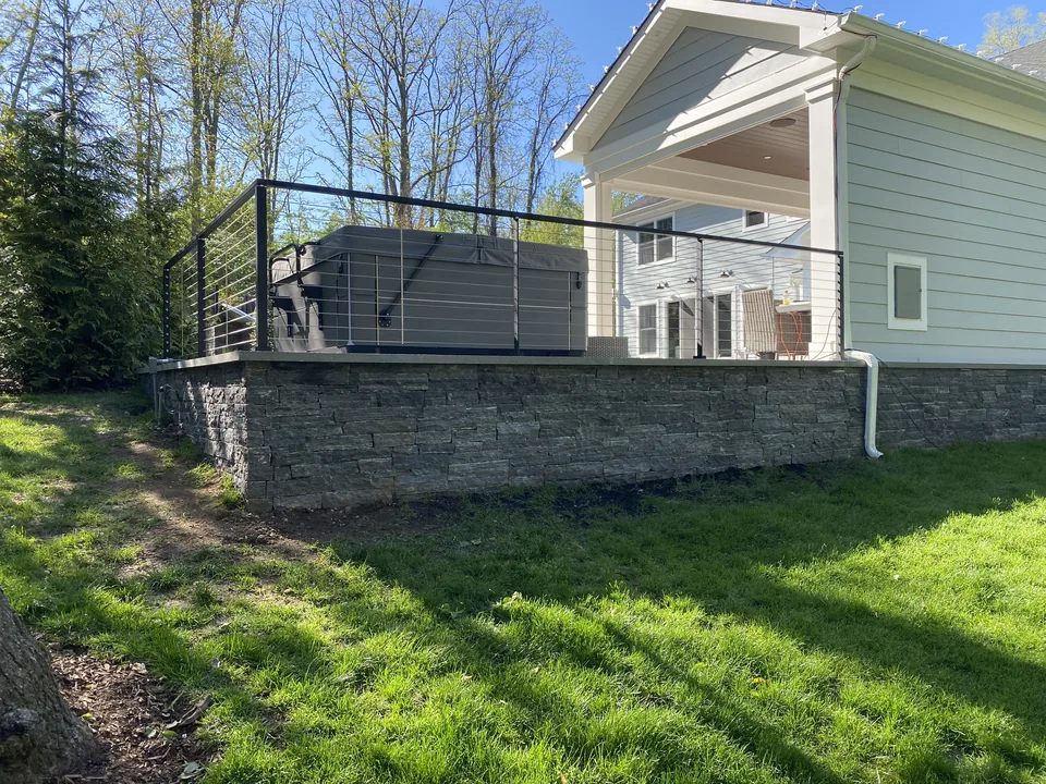 The long elevation seated on the natural stone retaining wall, St. James, New York