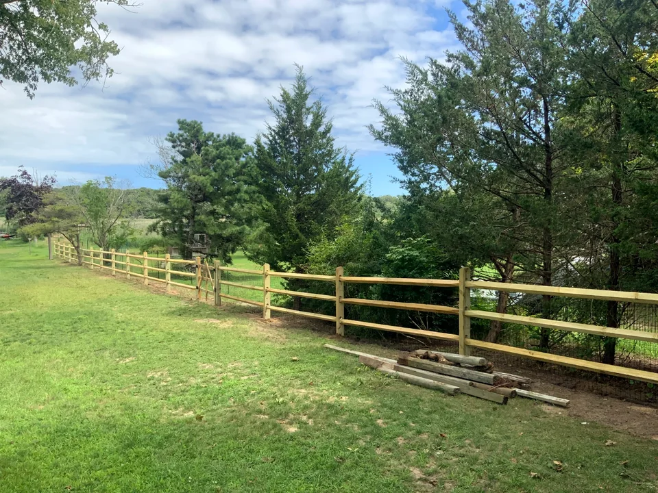 Landscape view of three-rail split rail fencing in Patchogue, New York.