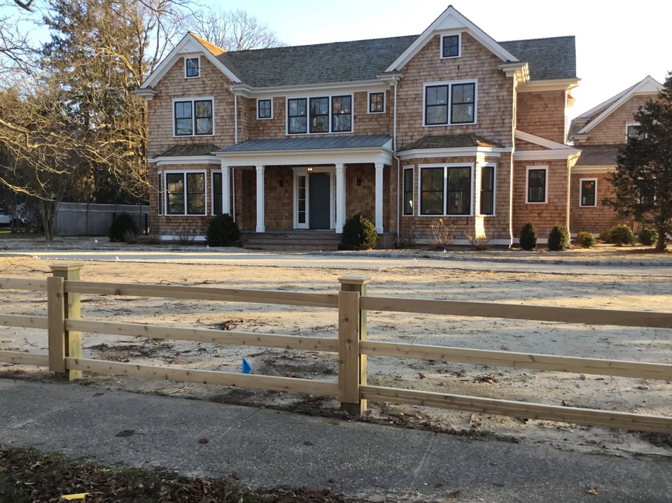 Front elevation of a custom three-rail board fence at a Remsenburg residence.