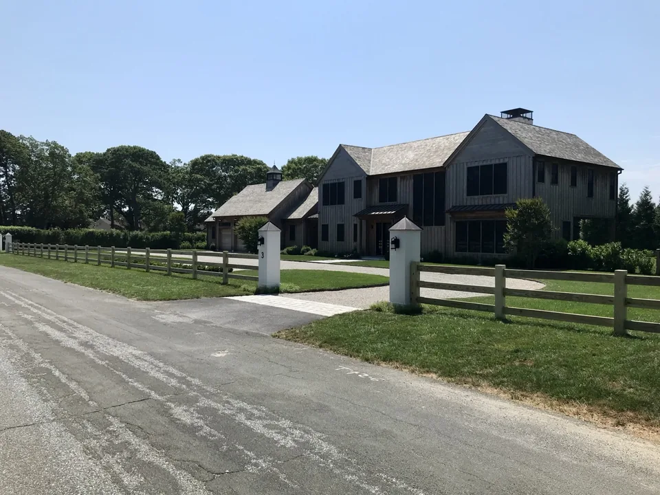 Post and rail fence beside a Remsenburg driveway entrance