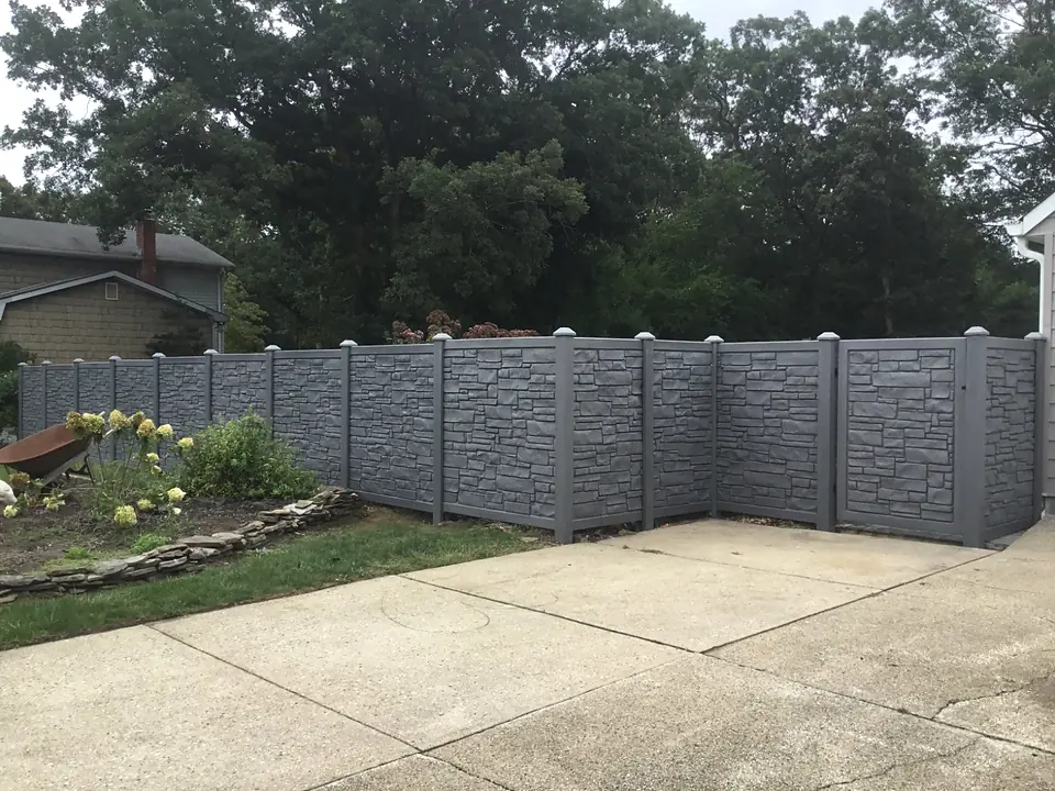 Gray stone-look SimTek privacy fence with a matching gate beside a driveway
