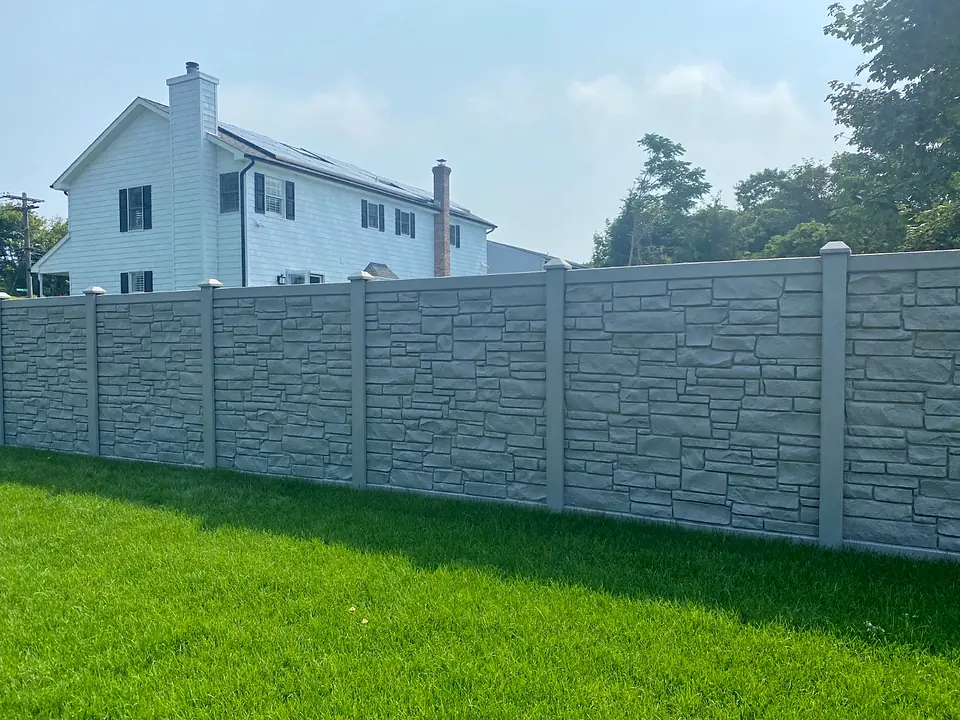 Gray SimTek stone-look privacy fence beside a finished green lawn