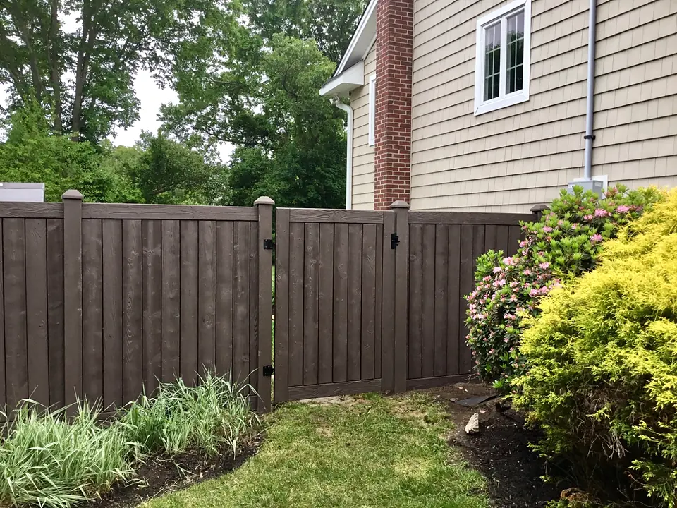 Dark wood-look SimTek privacy fence with matching walk gate and black hardware